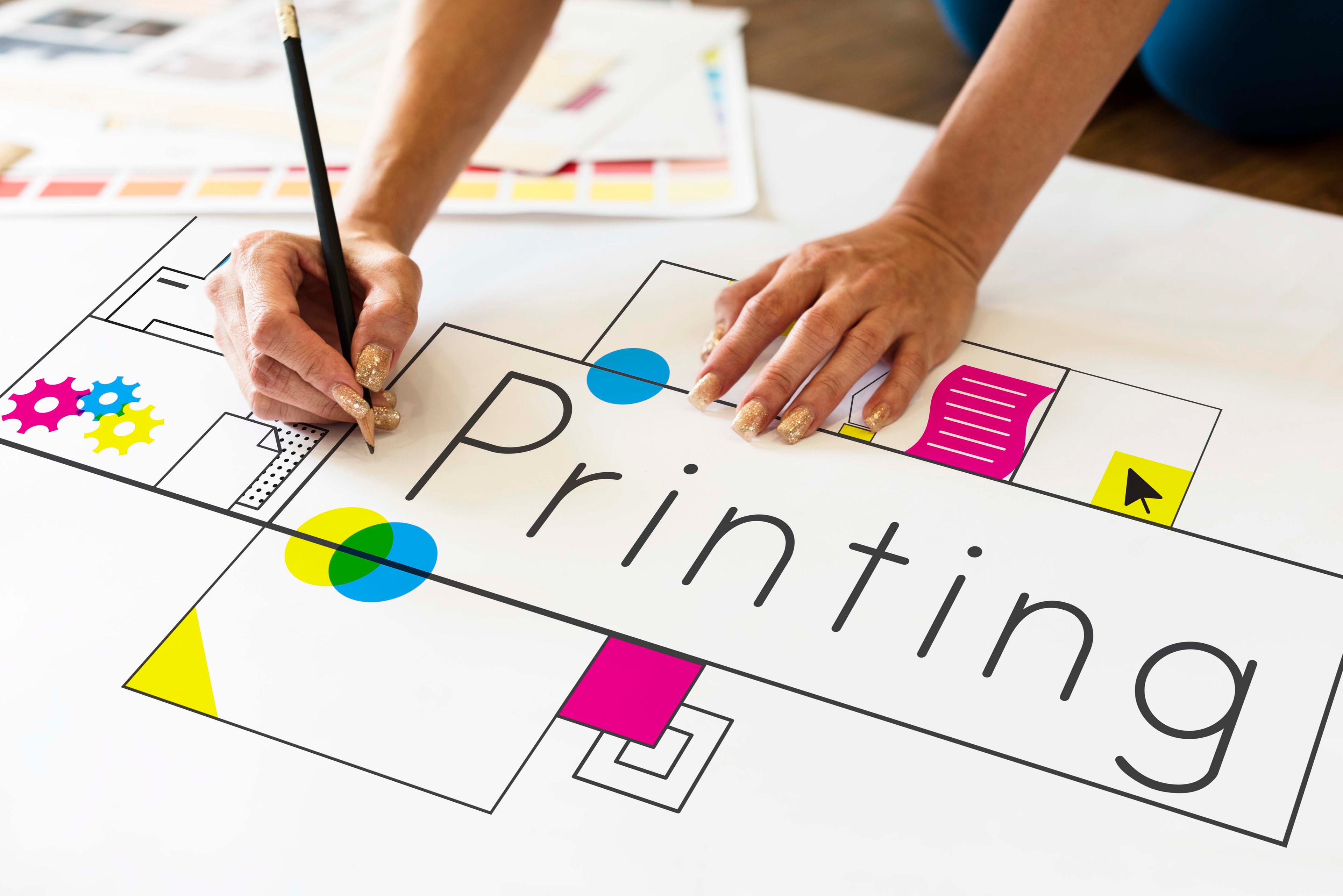 Hands working on printing design with network overlay